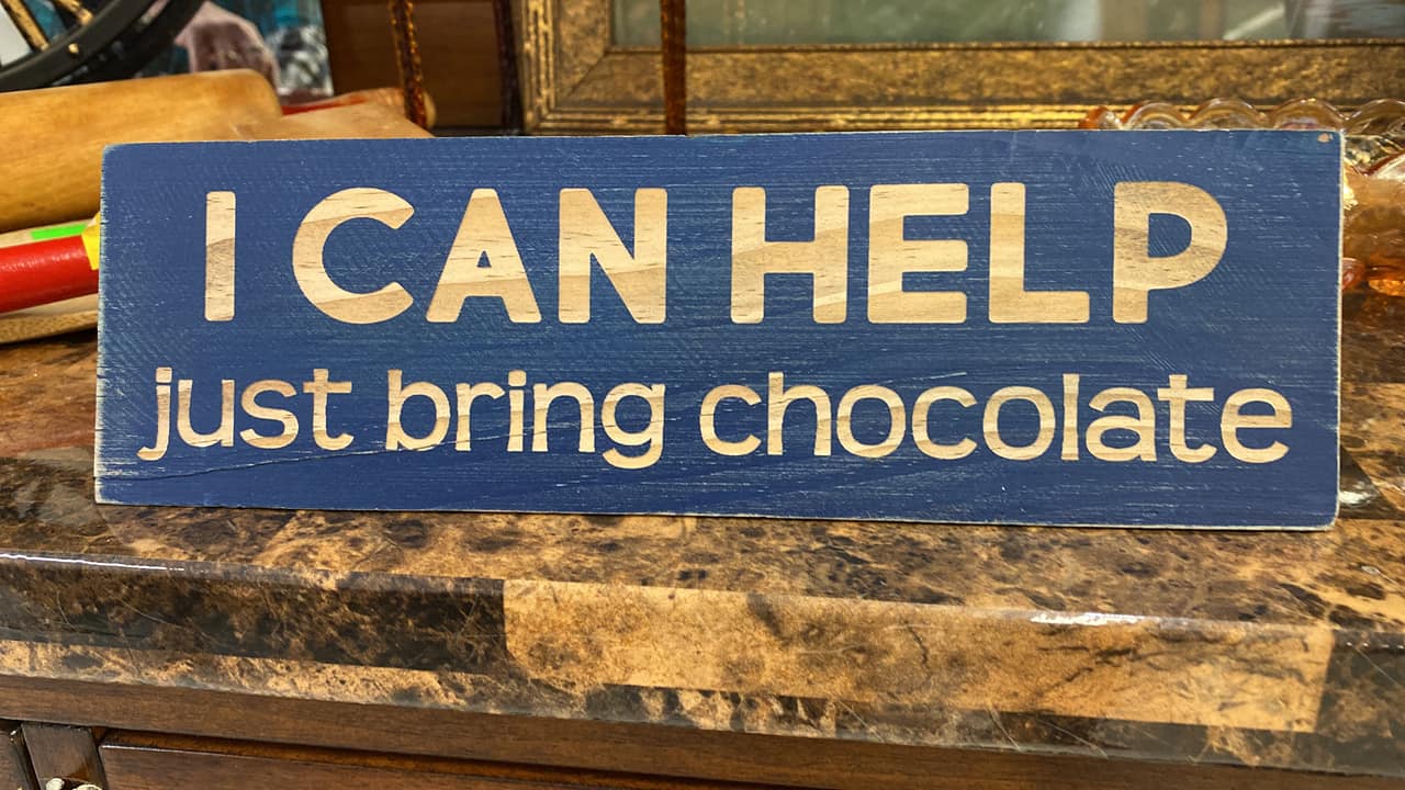 Wooden sign among vintage items at The Treasure Chest